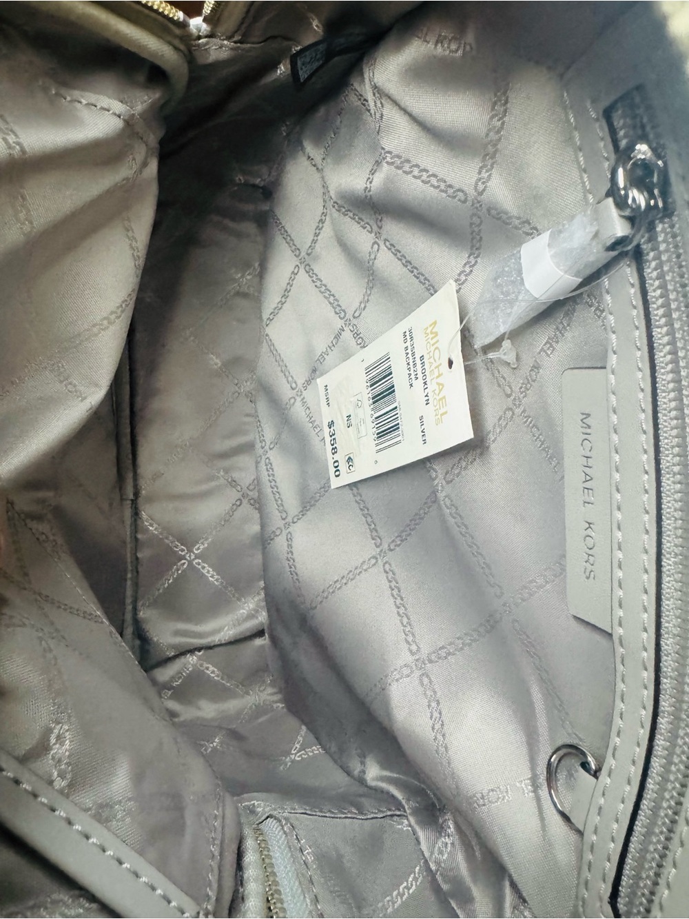 Michael Kors Metallic Silver MK Embossed Logo Backpack - Picture 9 of 9